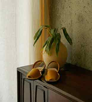Pons classic avarcas in mustard featured in a press clipping.