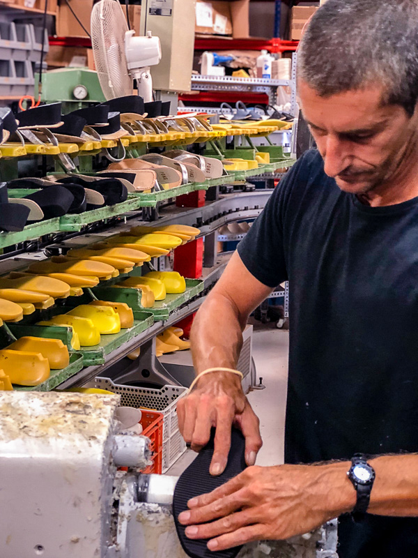 Craftsman working on a pair of PONS shoes