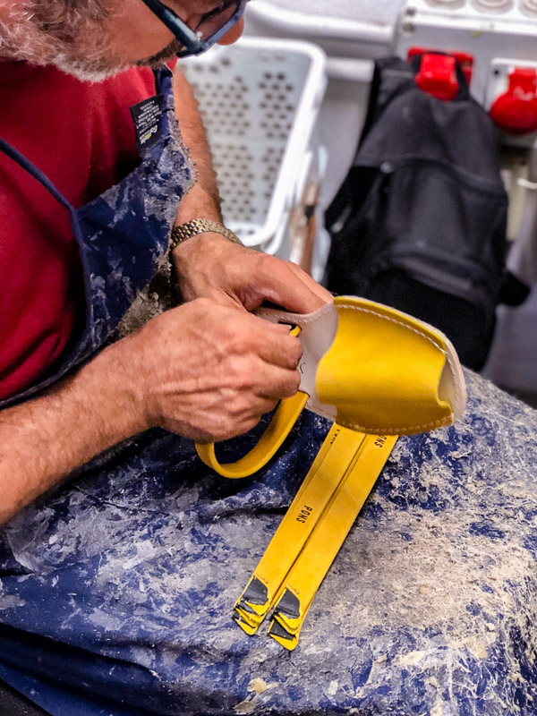 Man working on a pair of Pons at the Pons shop in Menorca