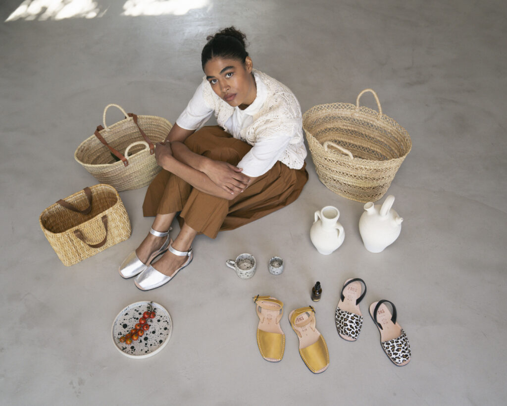 Model Briana poses wearing Pons silver ankle strap, surrounded by other Pons and Mercado items, like our popular Mercado bags