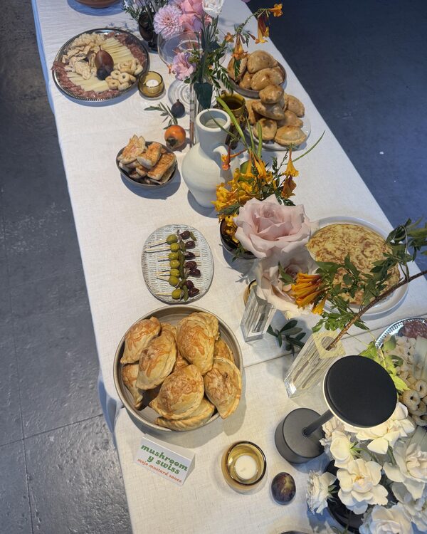 The anniversary table decorated with flowers and Mediterranean food